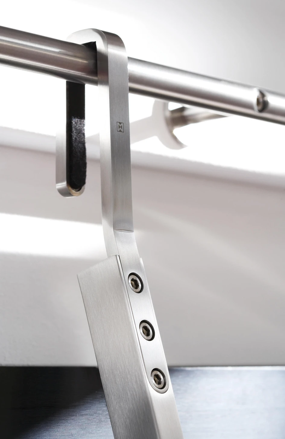 The Hook system from MWE can simply be pushed back towards the wall or shelving, to take up less space when out of use