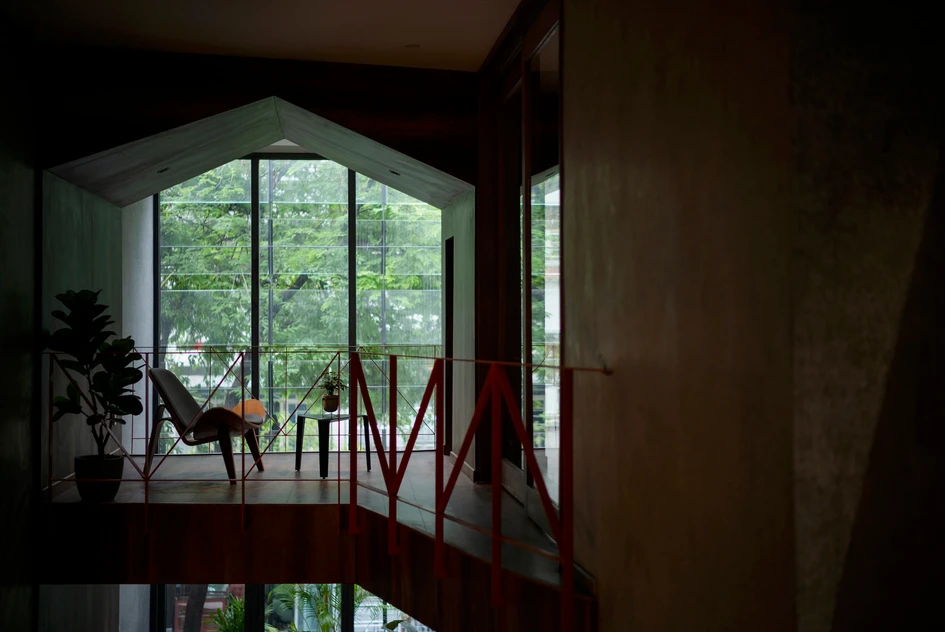 The narrow Bao Long Office in Ho Chi Minh City knocks through into the neighbouring unit to connect the mixed-use development with a striking orange staircase. Photos: Quang Dam