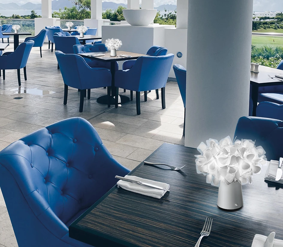 Moveable wireless lamps like Ease (top) from Muuto or a Clizia Battery bouquet (middle, bottom) from Slamp, bring the beauty, romance and freedom of a candle to tables inside and out