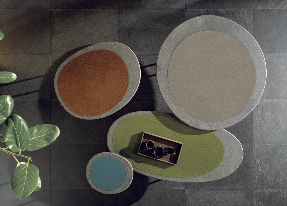 The Isole family of coffee tables in lava stone and glass, crafted in irregular, organic shapes like islands