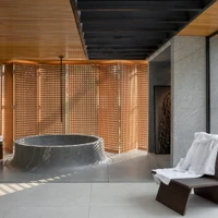 Incorporating wood accents or furniture can create a relaxing spa-like ambiance in projects like Bateia Bathroom Bungalow, balancing functionality with aesthetics. Photo: Estudio NY18, Daniel Mansur