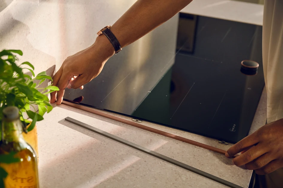 Flex Design offers magnetic trims that frame hobs and ovens in a variety of finishes, from Brushed Bronze and Anthracite Grey (seen here) to Deep Black and Metallic Silver