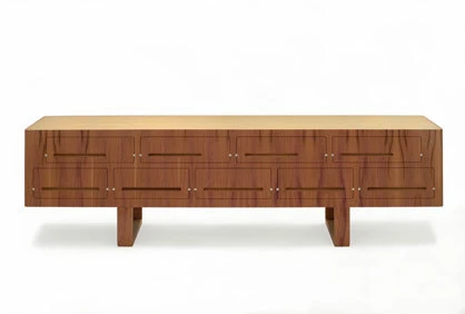 Sideboard «duna» von Nut + Grat hat eine Deckplatte aus eloxiertem Aluminium, die mit einer wellenförmigen Grafik bedruckt ist. Auf der Abbildung aus Zwetschgenholz.