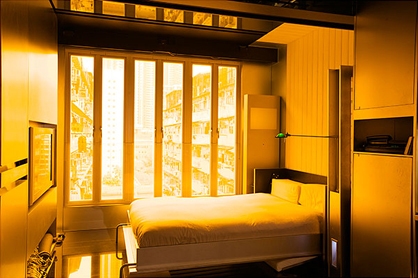 Mr. Chang uses a hydraulic Murphy bed of his own design, hidden behind a sofa during the day.