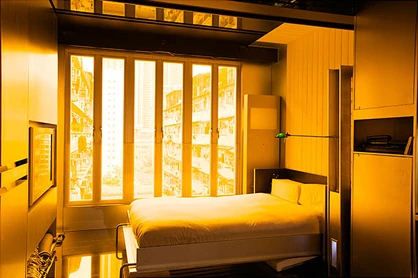 Mr. Chang uses a hydraulic Murphy bed of his own design, hidden behind a sofa during the day.