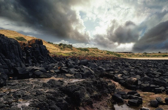 Black rocks at the coast, photo © Denton Corker Marshall