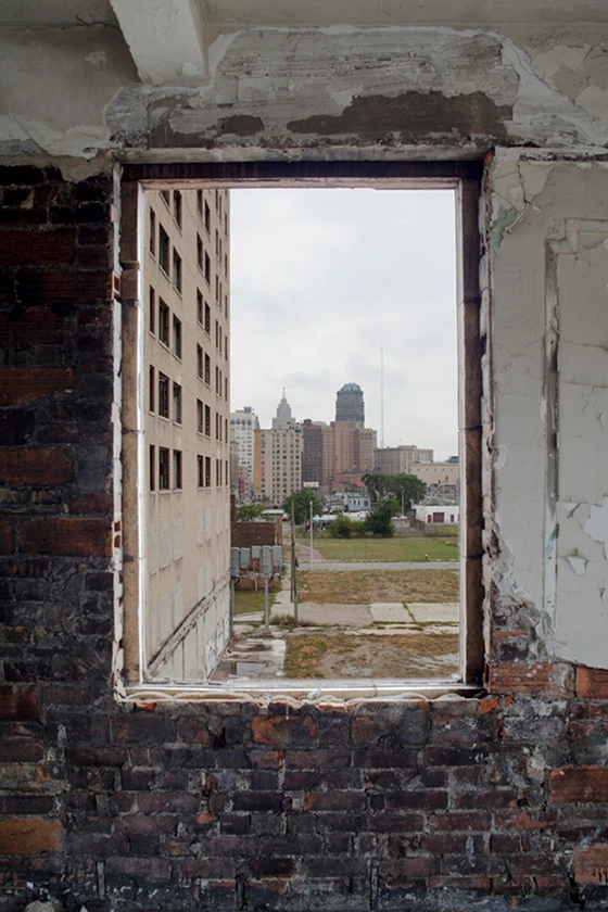 View of downtown Detroit through a window at Hotel Eddystone, one of Louis Kamper's three hotels on Park Avenue and one of the city's former main destinations; photo Sean Hemmerle