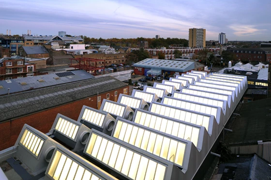 An independent steel structure has been inserted on top of the existing brick factory building to create several double-height (7 metres) studio spaces; architecture: Haworth Tompkins Architects, photo: Philip Vile