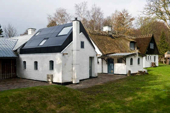The angled roofline and dark finish of the new structure ties in with the other buildings; architecture: Svendborg Architects, photo: Ole Hein