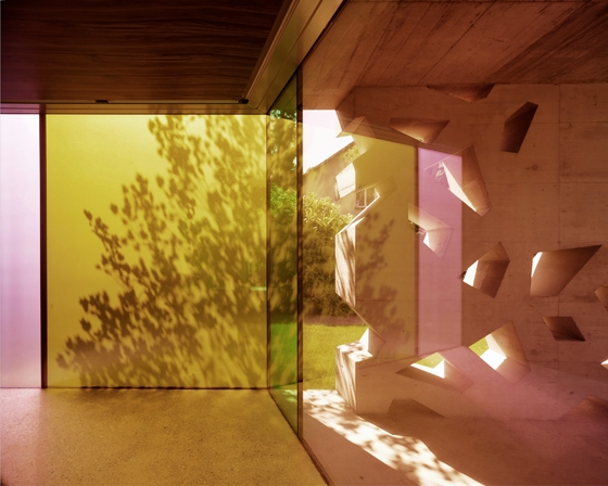 A small outdoor space at the Erlenbach cemetery building features perforated aerated-concrete walls. Inside, coloured opaque glass creates a contemplative air; photos Valentin Jeck