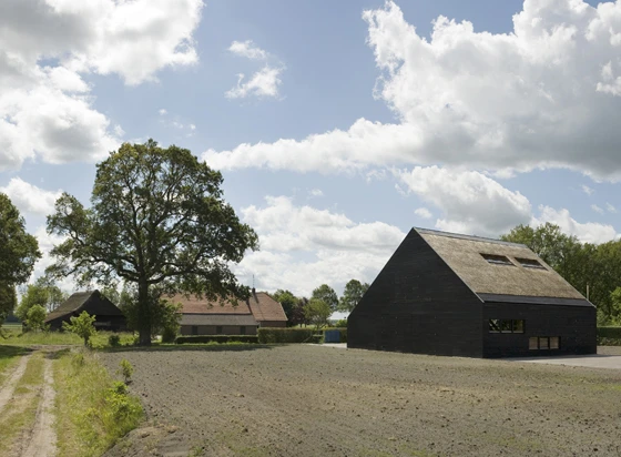 The form and proportions of B + B Bureau's 'Het Entreehuis' are in keeping with the existing farm buildings nearby; photo Lard Buurman