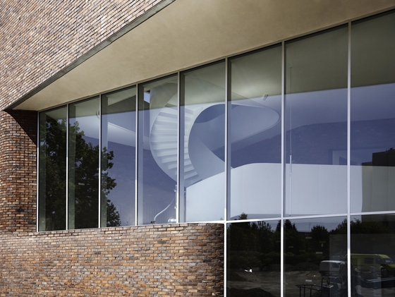 A spiral staircase links the three levels; photo: Julien Lanoo