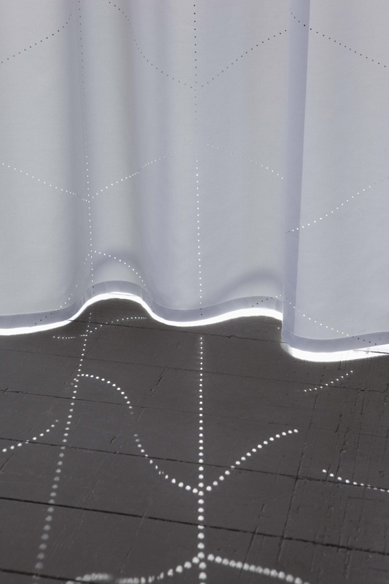 Kept in the dark: 'Dimmer Sky' black-out fabric, replete with laser-cut perforations, from Création Baumann