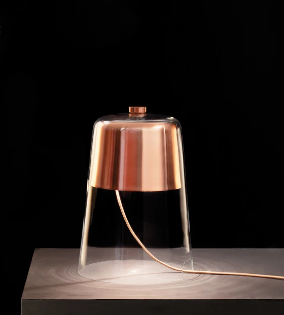 As its name would suggest, a formal and visual reduction is what Sam Hecht’s ‘Semplice’ table lamp for <b>Oluce</b> is all about. Sitting directly on the table, its glass and galvanised metal structure is topped with a dimmer knob