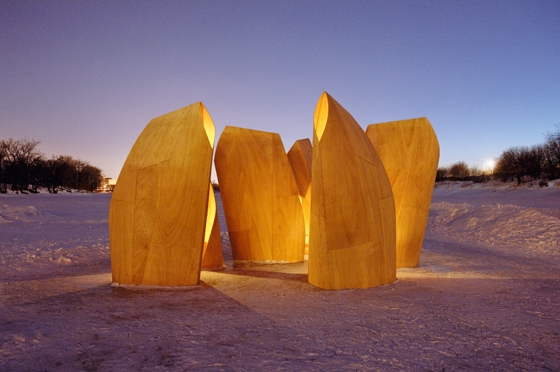 Patkau Architects' wooden shelters for skaters, installed on a frozen river in Winnipeg, Canada, in 2011, provide a place for resting as well as functioning as a sculptural intervention in the landscape, looking like a group of animals; photo James Dow