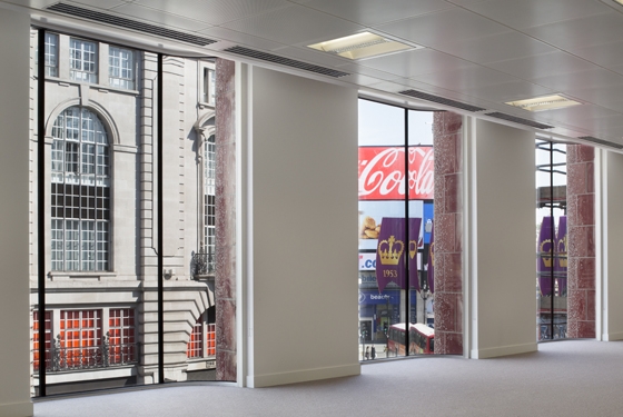 One Eagle Place’s interior overlooks Piccadilly’s flickering LED signs. The idea is that the latter are reflected on the building’s white faience facade; photo Dirk Lindner