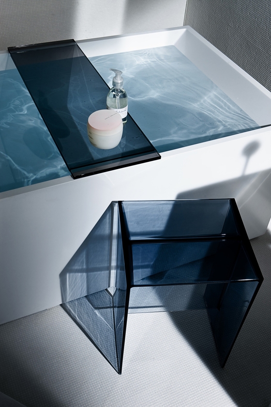 Colour becomes the prism through which the theatre of the bathroom interior is staged, with a palette of transparent hues, including tangerine orange and smoky grey, joined by opaque silver and gold, as well as a 24-carat gold plate