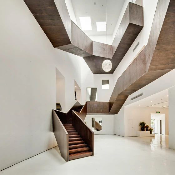 This boxy, wooden staircase twists up the interior of furniture retail outlet Design Collective near Shanghai, designed by Neri & Hu, offering visitors intriguing, contrasting views; photo Shen Zhonghai
