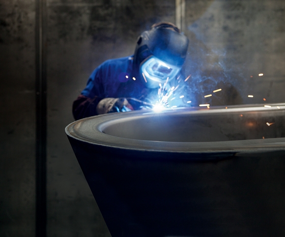 Hand-crafted: a welder at work on the "BetteStarlet Oval Silhouette" model. The free-standing top-end bath is even available in two colours on request