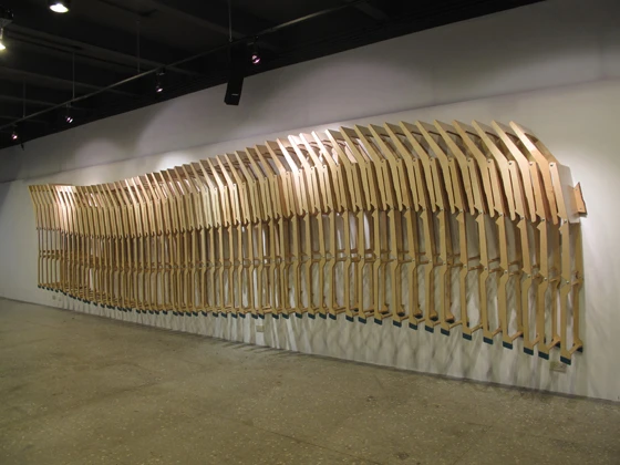 Die von Pilot:Wave entworfenen „L22“-Klappstühle für einen Vortragssaal im libLAB Buchladen in Taipeh werden, sobald sie nicht in Verwendung sind, an die Wand gehängt und verwandeln sich dort in eine Kunstinstallation mit wirbelartigem Muster