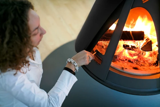 The 'Pharos Interior' stove, suspending from the ceiling, functions beyond its utilitarian purpose as an impactful interior-architectural element