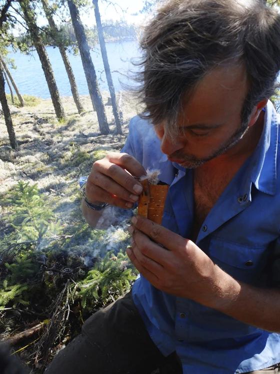 Bart Leenders gets things started: lighting some kindling in Canada