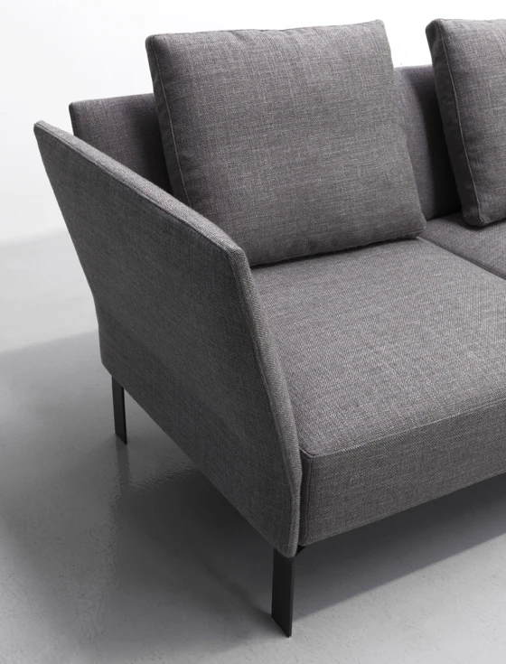 The slender arms and back of Gordon Guillaumier’s Jermyn sofa help to reduce its visual mass and are complemented by the space underneath resulting from raising the seat above the floor on thin metal legs