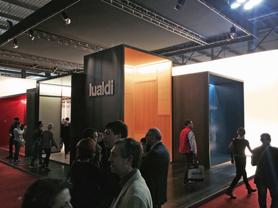 Visitors circulate around Lualdi Porte's stand in Milan, which is articulated as a conjoined series of differently sized show cabinets