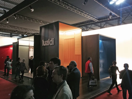 Visitors circulate around Lualdi Porte's stand in Milan, which is articulated as a conjoined series of differently sized show cabinets