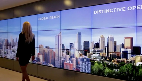 Interactive wall communicates company information, while motion sensors detect a person’s presence, altering content to suit his or her level of engagement