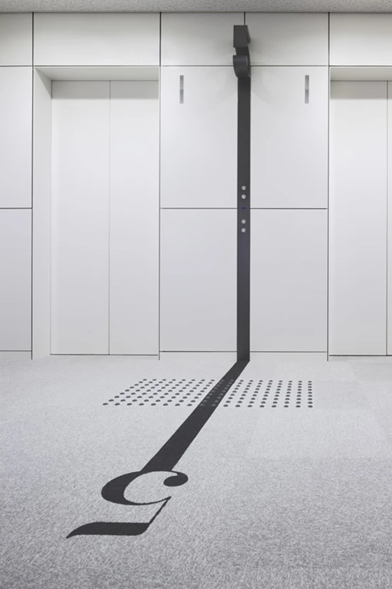 Office building in Naniwa-ku, Osaka, Japan, featuring strong typographical elements that flow seamlessly from architectural features to graphics on the floor