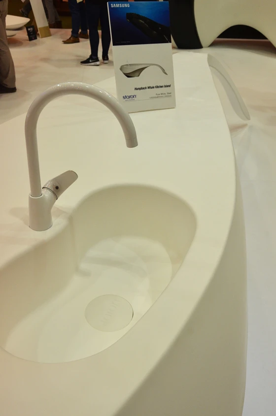A basin cast into the top of the sculptural Humpback Whale Kitchen Island showed how the seamless solid material creates non-porous hygienic surfaces