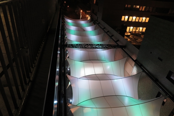 Made of Sefar’s Tenara fabric, architect Nikolai Kugel’s visually intriguing canopy over the Metzergasse in Buchs, Switzerland, was wind-tunnel-tested before installation and is fully retractable