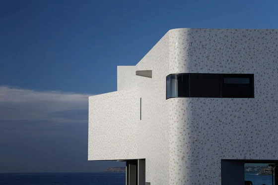 The facades of the North Bondi Surf Life Saving Club by Durbach Block Jaggers are entirely clad in an irregular pattern of mosaic tiles that wrap around its curving corners; photo: John Gollings