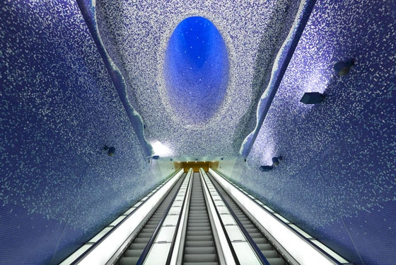 The tiles extend across the interior of a funnel that stretches to the surface and brings light into the subterranean spaces; photo: Andrea Resmini