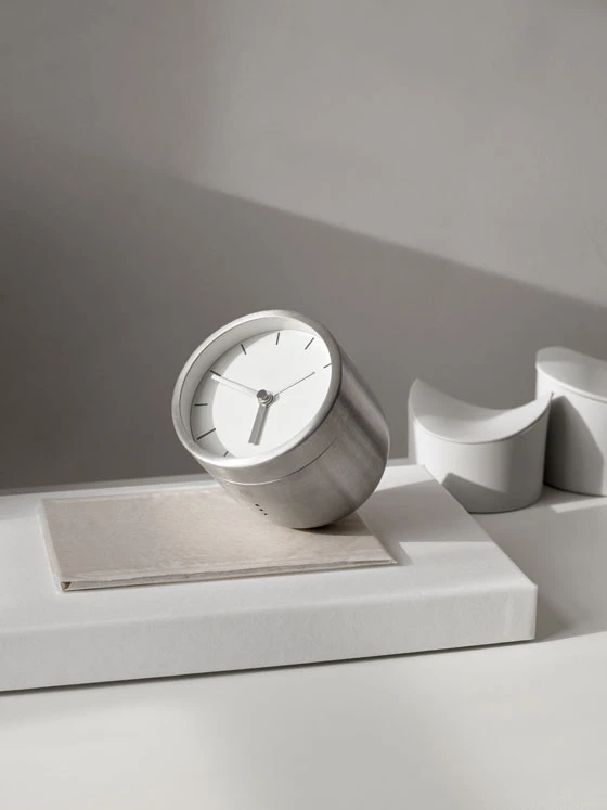 Stick System shelving (top) wears its construction well, the tubular framework reminiscent of functional Bauhaus industrial design. The Norm Tumbler Alarm Clock (above) is weighted to tilt face-up