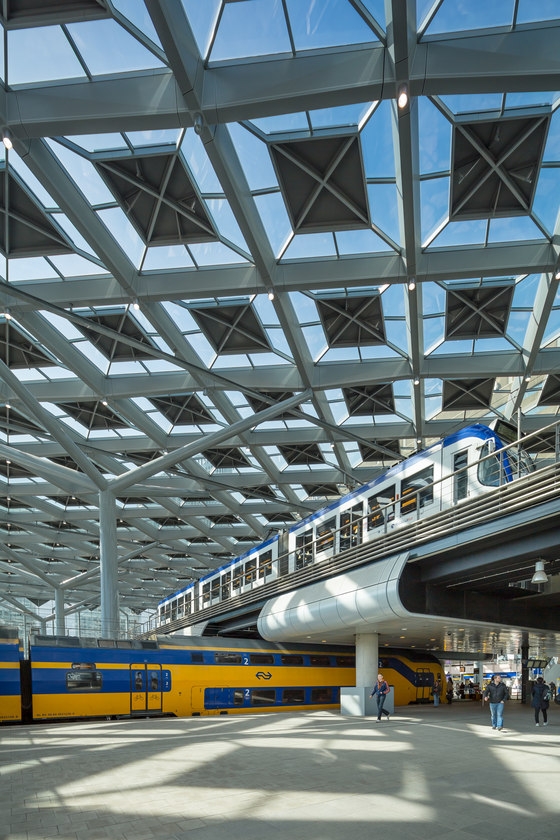 Benthem Crouwel’s new Hague Central Station features a glass roof the size of two football pitches that is supported by eight branching columns. Elevated tram lines traverse the railway platforms, transforming the building into a bustling hub