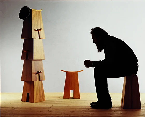 Michele de Lucchi sitting on the <b>Bisonte</b> stool (Birch plywood) Produzione Privata, 2005 - Photo © aMDL