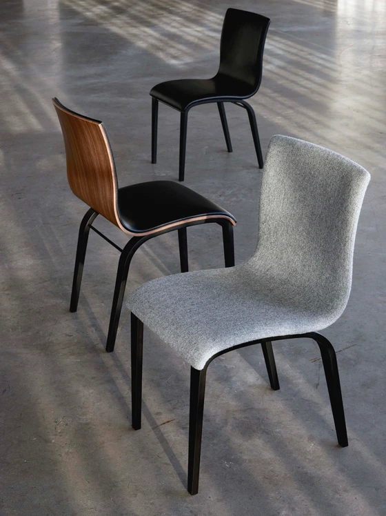 Another view of the elegant City lounge chair whose backrests are cradled by curved panels of wood (top); the simple Jazz table rests on three tapering legs (middle); illustrating the company's predeliction for gentle curves: the Copenhagen chair (above)