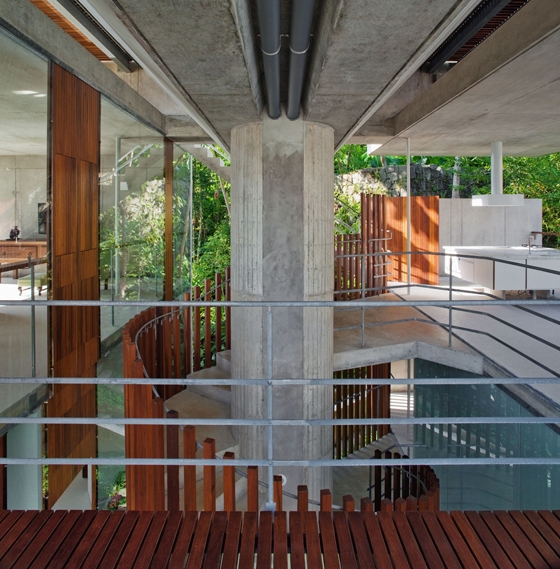 SPBR Arquitetos's coastal home in Ubatuba, Brazil, connects beach with street level, rising up 28 metres through lush, tropical foliage thanks to its three supporting concrete columns. Photos: Nelson Kon