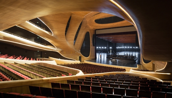 The dramatic, curvilinear, aluminium-clad form of Beijing office MAD Architects’ opera house in the Northern Chinese city of Harbin houses, cocoon-like, an ash-panelled, 1600-seater auditorium, a smaller theatre, and a public plaza; Photos: I. Baan