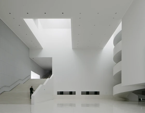 Articulated externally as a concatenation of gabled volumes, Spanish practice Barozzi Veiga’s Szczecin Philharmonic Hall in Poland underscores its eschewal of the monolithic with its backlit glass-ribbed facadet; Photos: Menges, Hufton + Crow