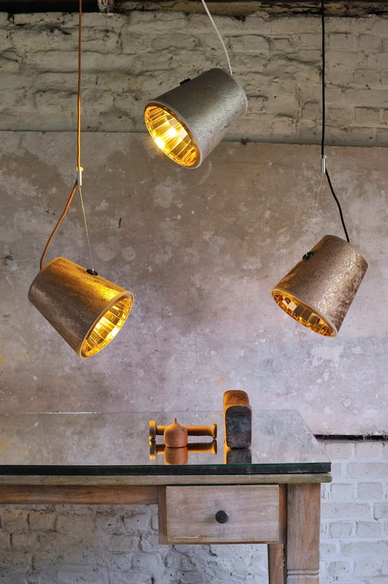 Top: Hind Rabii in the building in Stembert, Belgium, where her lights are manufactured. Shown here, her Reflector Drop lights. Centre: The company’s Reflector Wall light. Bottom: Rabii’s Tension pendant lights, which combine glossy and matt surfaces