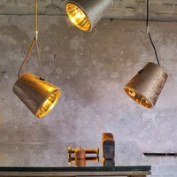 Top: Hind Rabii in the building in Stembert, Belgium, where her lights are manufactured. Shown here, her Reflector Drop lights. Centre: The company’s Reflector Wall light. Bottom: Rabii’s Tension pendant lights, which combine glossy and matt surfaces
