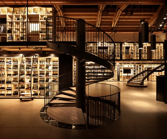 Top: Lighting design helped transform this Blenheim Palace interior into a space of retail discovery. Above: LLG's team was instrumental in giving the warehouse-like Ferrowine wine store bright shelves but a cozy shop