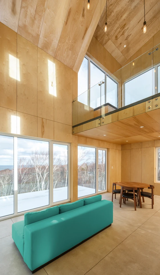 Architect Omar Gandhi and Design Base 8's Rabbit Snare Gorge project in Canada's Nova Scotia features an archly gabled roof, Corten-steel-framed entrance and a glazed, first-floor balcony. Photos: Doublespace Photography