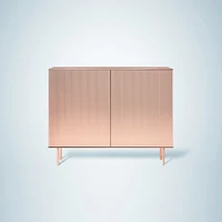 Volte (top) by French designer Constance Guisset features a timber structure wrapped in délabré copper. Nathalie Dewez’s polished copper Elizabeth cabinet (above) with its plissé facade demonstrates De Castelli’s incredible bending techniques