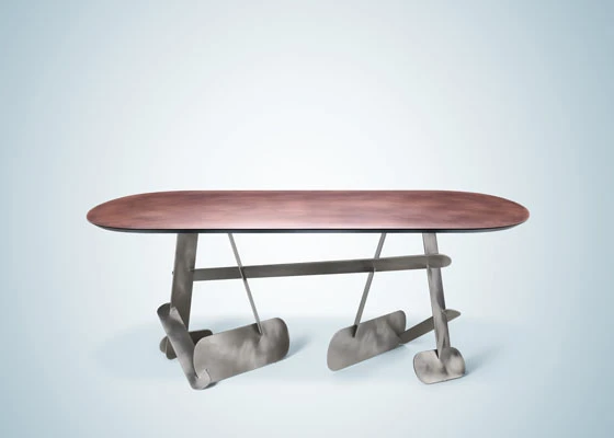 Donata Paruccini’s Vomere table is designed to “express lightness and freedom from formal schemes”. The rounded structural elements and orbital délabré copper top lend a softness to this Meccano-like metal piece