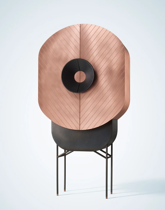 Italian designer Elena Salmistraro’s Polifemo cabinet was inspired by the one-eyed Cyclops of Greek mythology. The timber structure is covered in copper engraved with a chevron pattern and the handles masquerading as the central eye