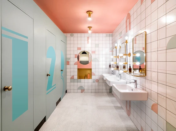 The whimsical palette continues in the parlour-like restrooms at WeWork Weihai Lu with wall tiles featuring green and pink shapes and bronze accents in mirrors and lighting. Photos: Jonathan Leijonhufvud (1,2,3,5), Dirk Weiblen (4)